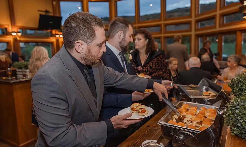 Man choosing food from buffet at Black Bear Bear Den Grille.